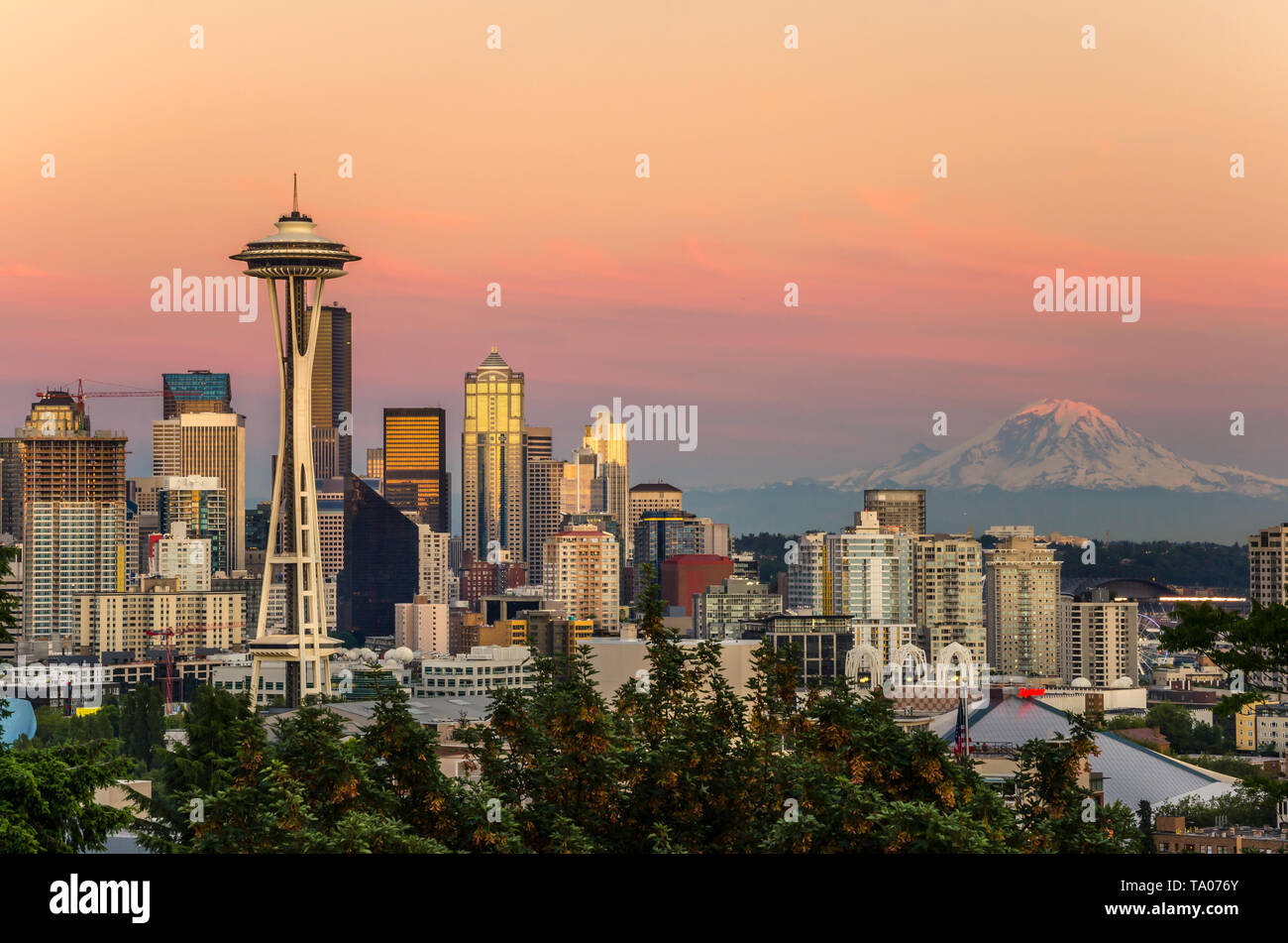 Majestic view of Seattle skyline vith a Snow-capped Mount Rainier in Background at Sunset Stock Photo
