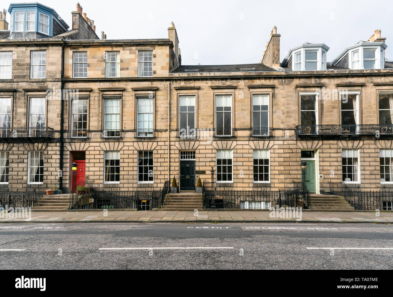 Traditional British terraced houses with colourful wooden front doors