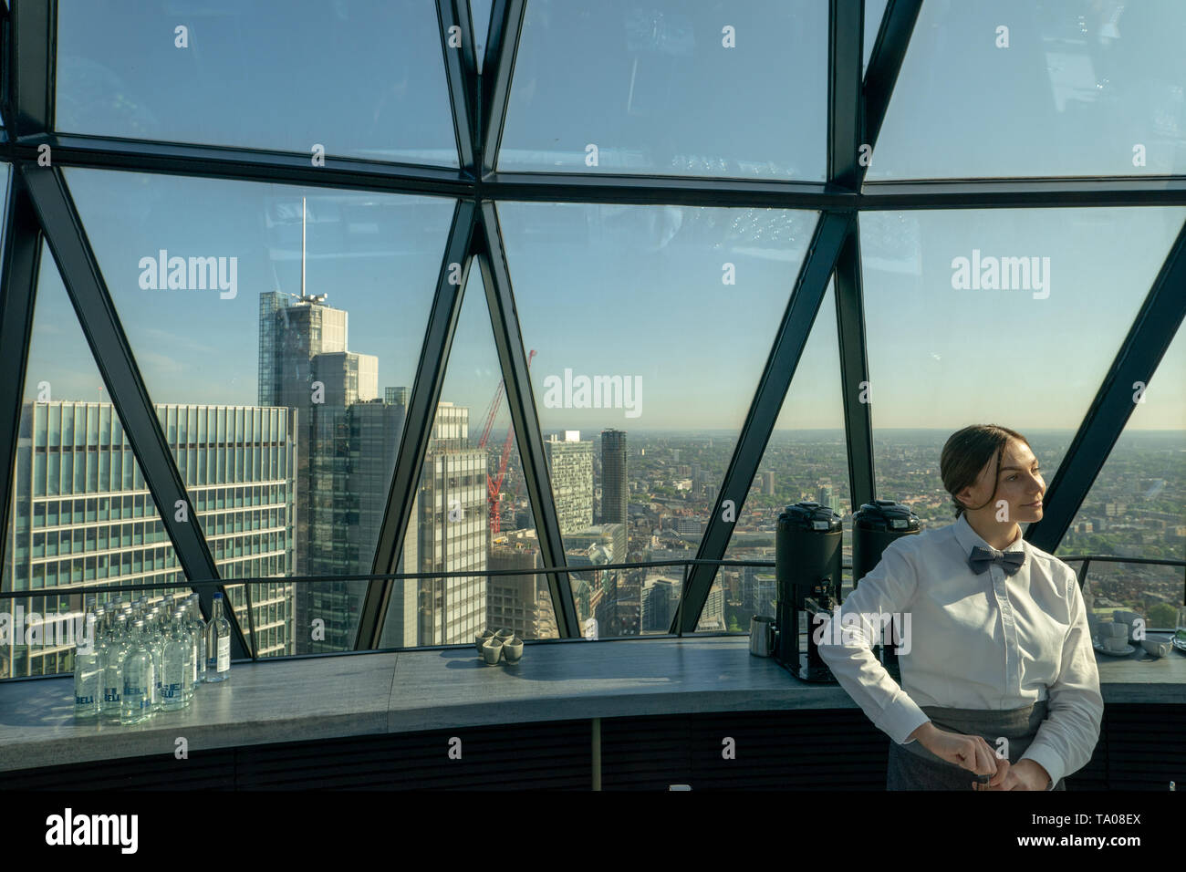 A waitress at Searcys on the top floor of the Gherkin building in London. Photo date: Tuesday, May 21, 2019. Photo: Roger Garfield/Alamy Stock Photo