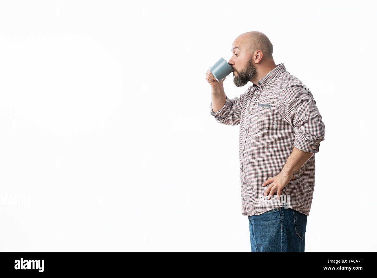 Handsome man with blue glasses drinking coffee Stock Photo