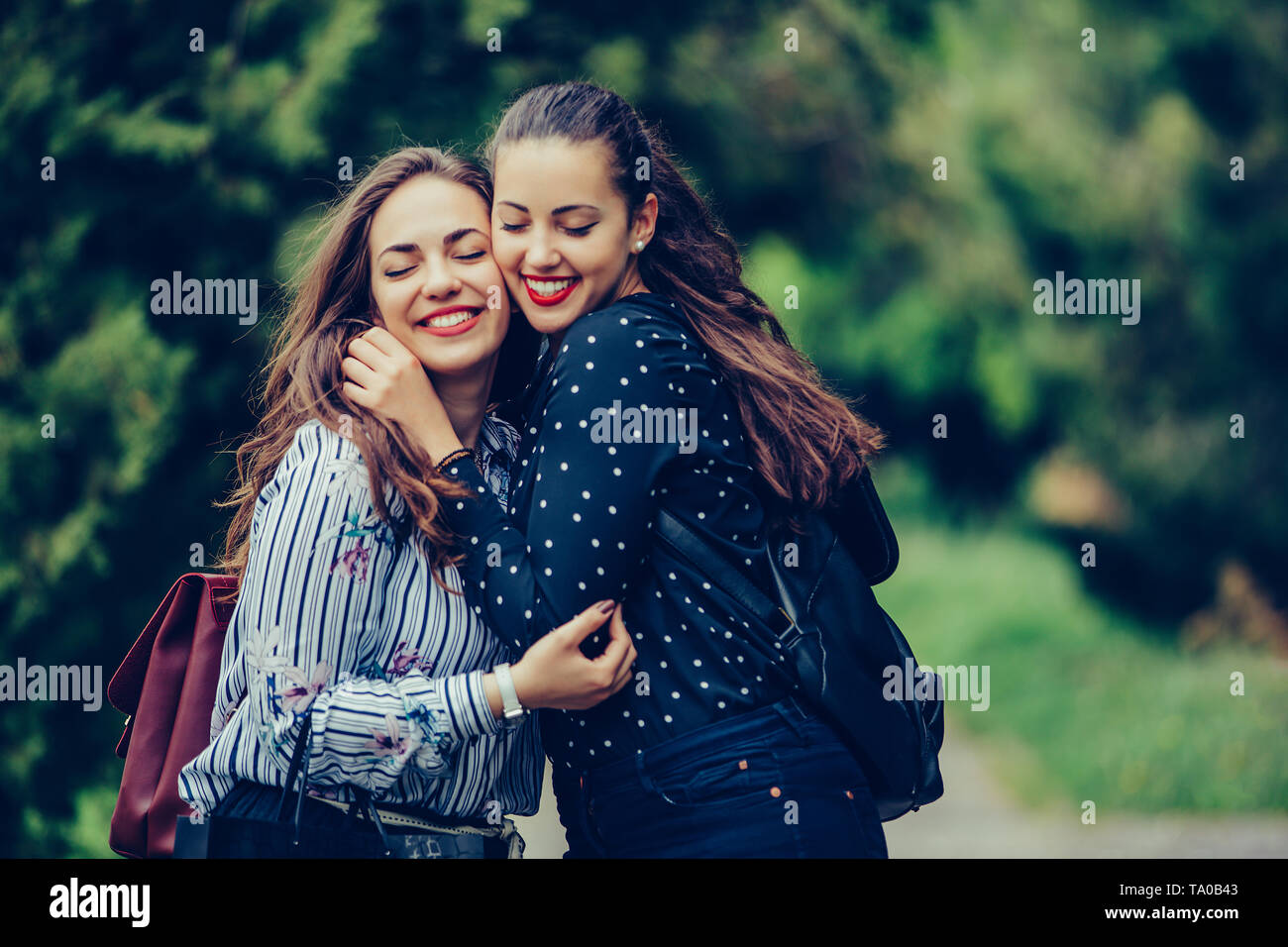 Close up two girls hugging other hi-res stock photography and images ...