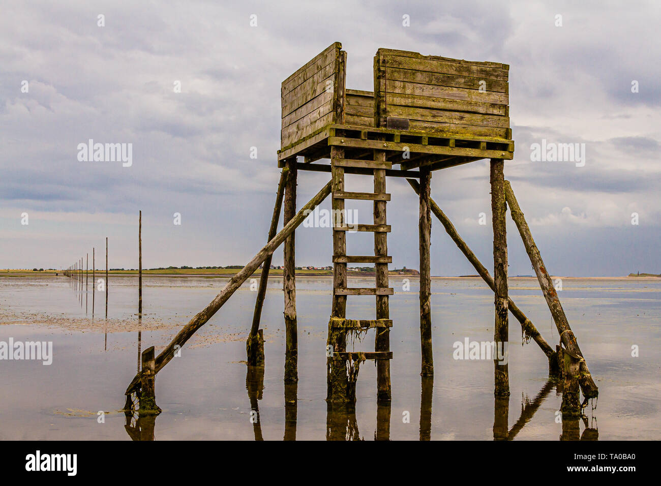 A refuge box for walkers caught out by the tide on the Pilgrims' Way, Holy Island of Lindisfarne, Northumberland, UK. July 2018. Stock Photo