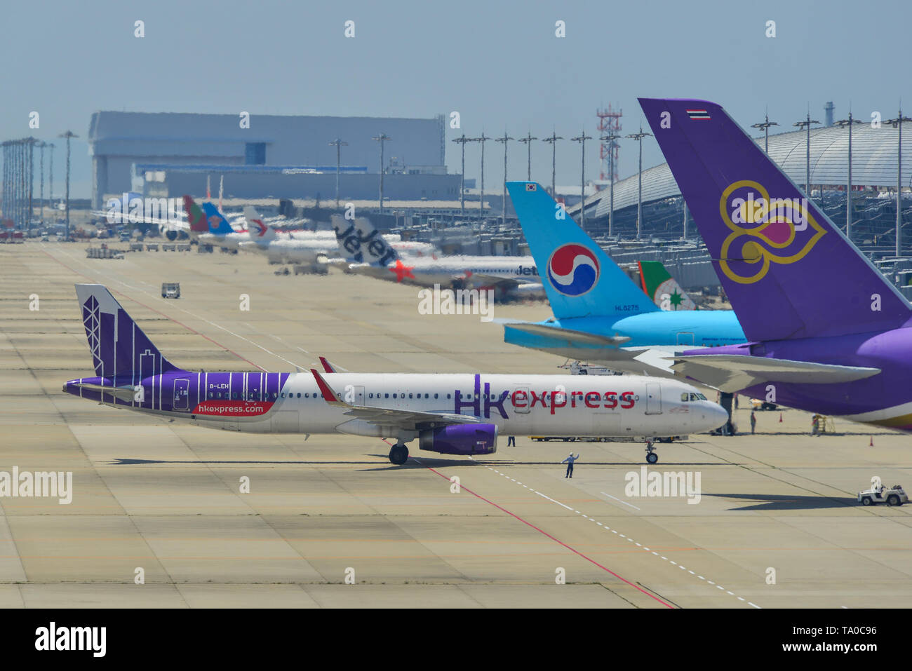 Osaka, Japan - Apr 18, 2019.  B-LEH Hong Kong Express Airbus A321 taxiing on runway of Kansai Airport (KIX) in Osaka, Japan. Stock Photo