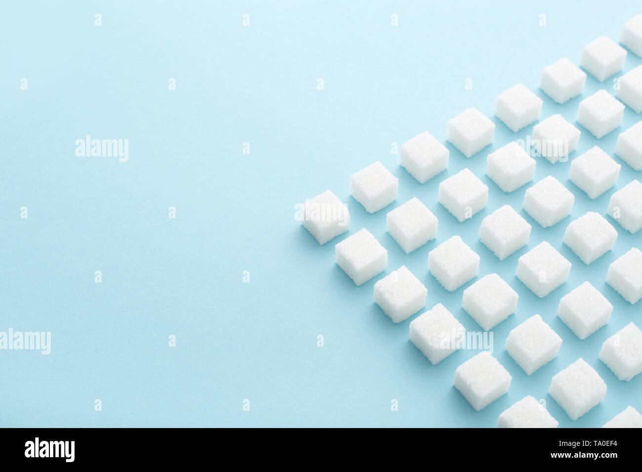 Sugar cubes geometry pattern on pastel blue background with copy space. Abstract, creative, minimal style. Stock Photo