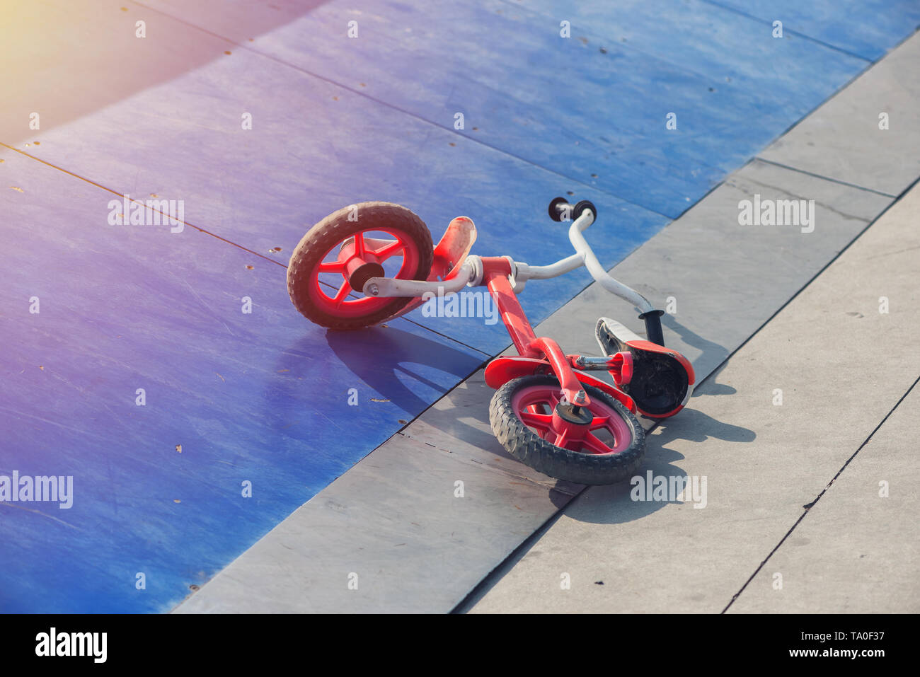 Little kid's bicycle down on a skateboard ramp park Stock Photo Alamy