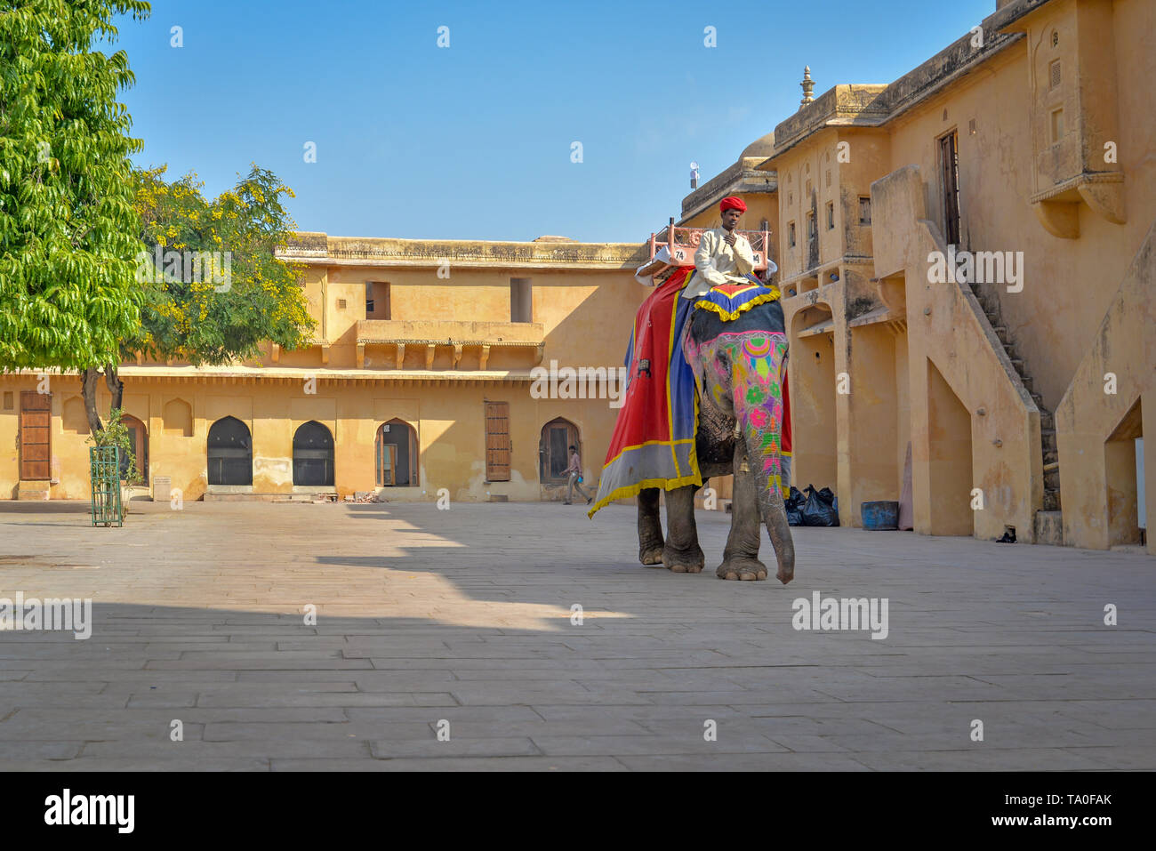 AMBER, INDIA - DECEMBER 5, 2015: Elephant keeper and its very elaborately adorned elephant at the Amber Fort Stock Photo