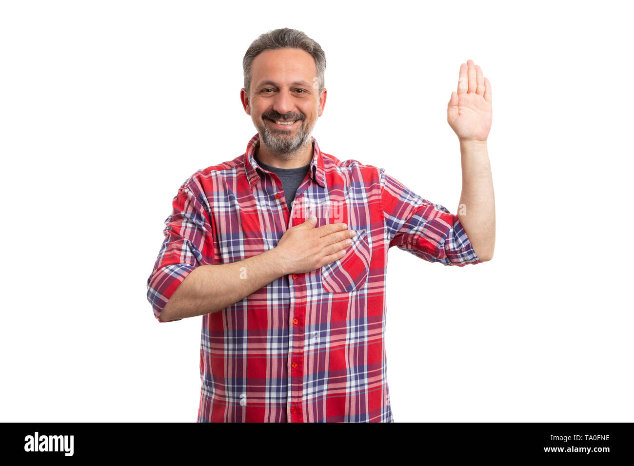 Trustworthy man making honest oath gesture with palm up and touching heart isolated on white background Stock Photo