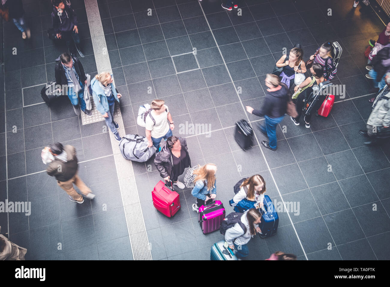 Berlin, Germany - May,  2019: Group of elder people with luggage at train station platform entering S-Bahn  train at Berlin Hauptnbahnhof Stock Photo