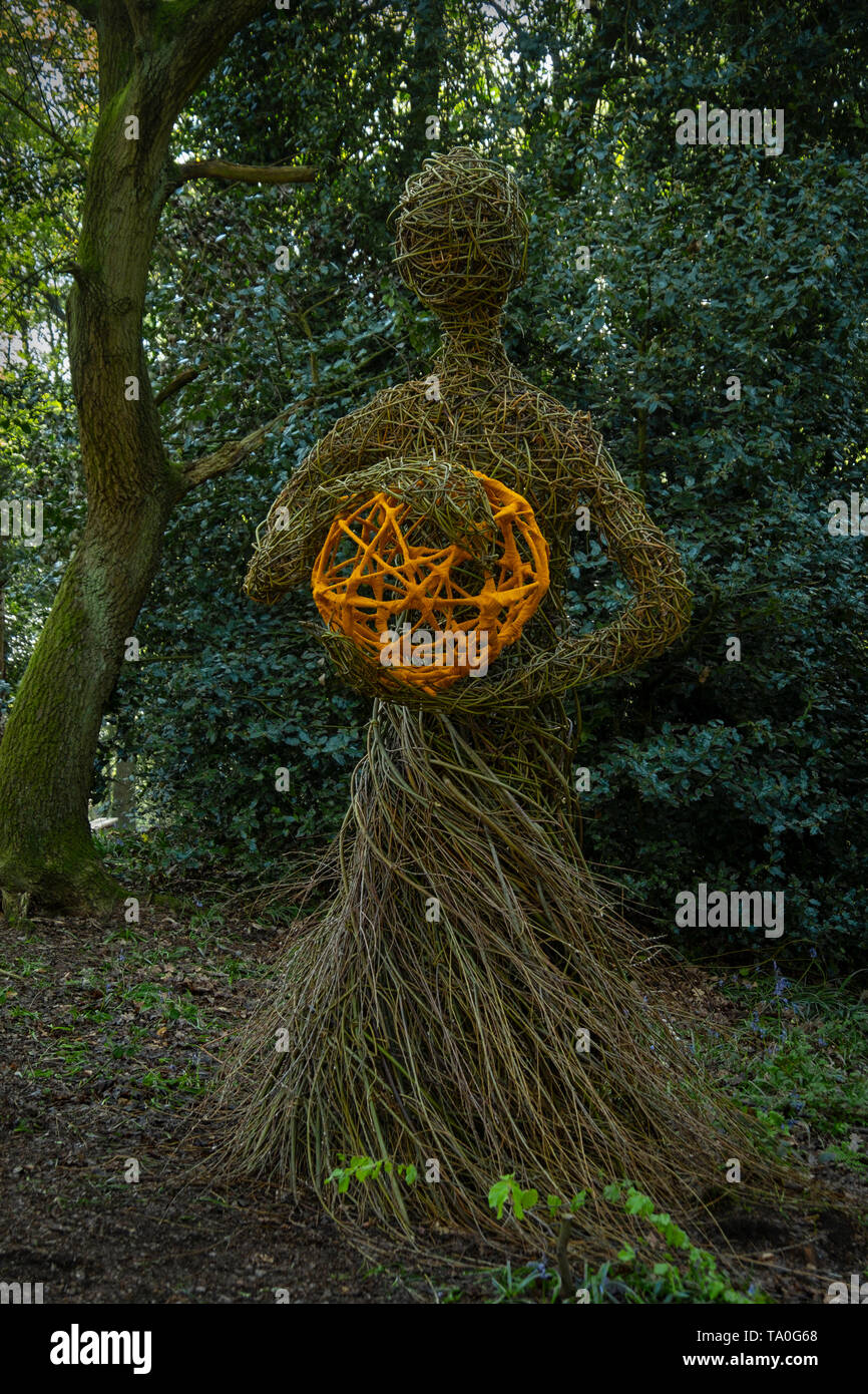 Artwork statue made in Willow Withies in woodland. Stock Photo