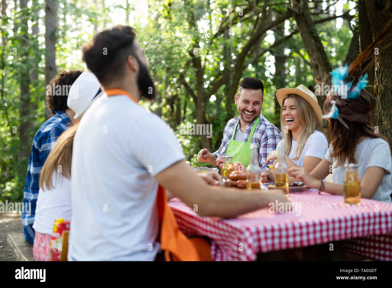 Group of happy friends having a barbecue party in nature Stock Photo ...