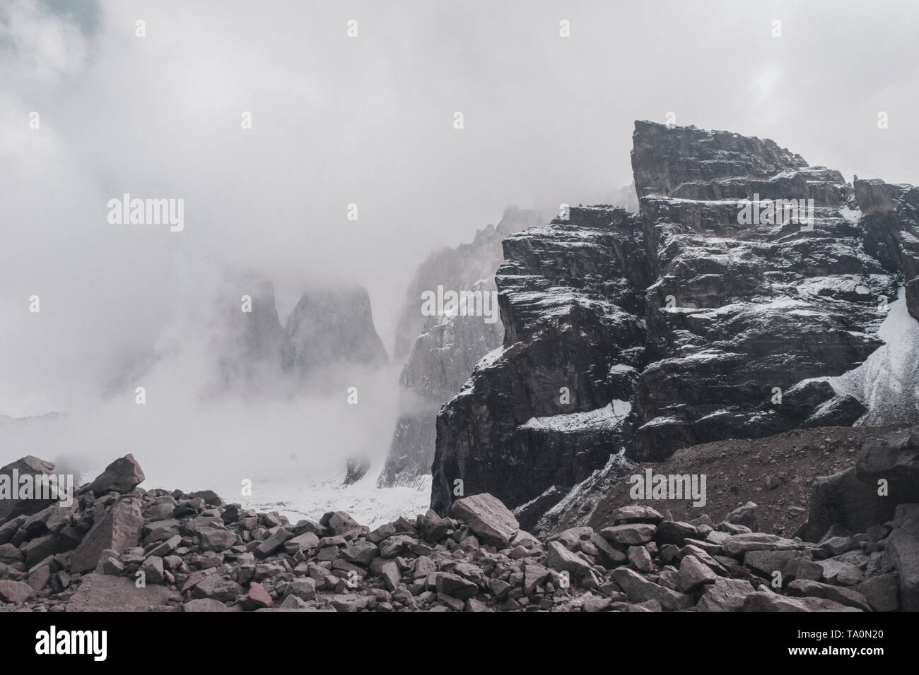 The Torres del Paine shrouded in fog in the Patagonia of Chile, trekking to the Paine Towers Stock Photo