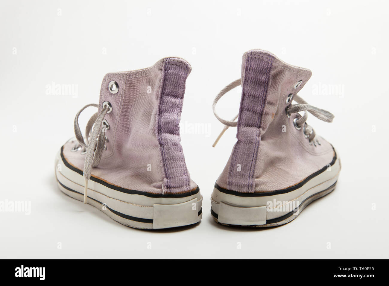 A pair of pink old basketball sneakers isolated on white background ...