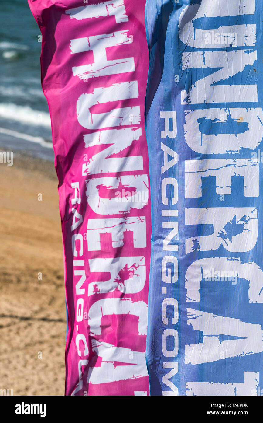 Colourful banners advertising the ThnderCat Racing UK Championship at Fistral in Newquay in Cornwall. Stock Photo