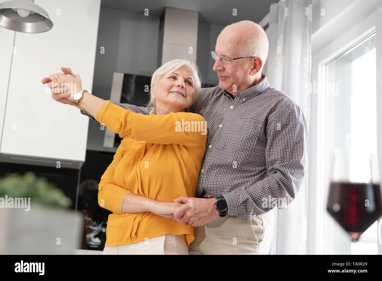 Senior couple dancing and smiling at home. Happy couple of pensioners Stock Photo
