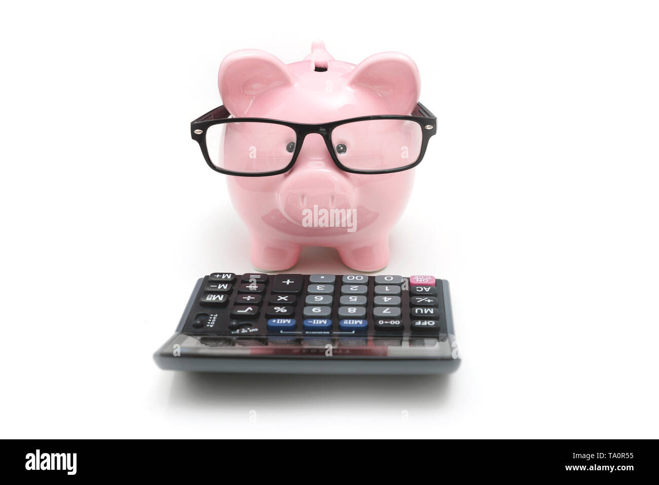 Piggy bank and calculator on white background. Savings and budget ...
