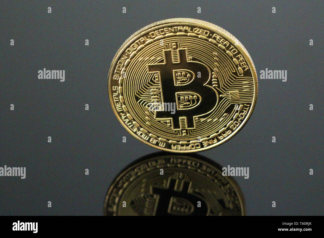 One gold coin bitcoin on a black background. Bitcoin is on its side. One  can see his reflection. Cryptocurrency concept gold bitcoin. No people,  empty Stock Photo - Alamy