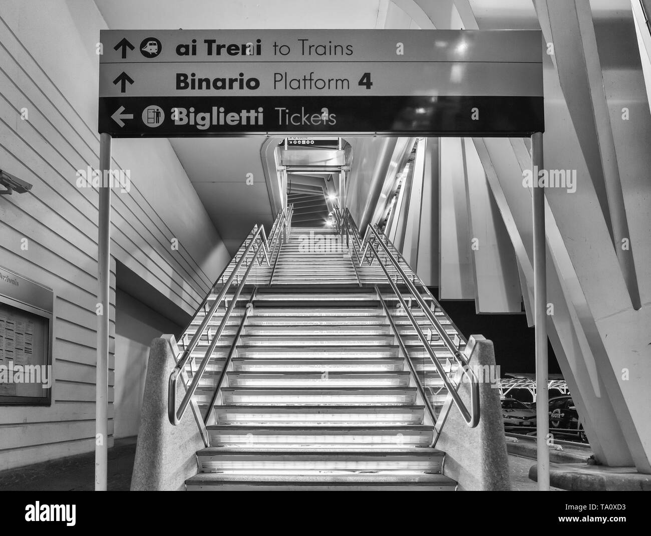 Reggio Emilia, Italia, May 16, 2019: high speed train station Reggio Emilia, stairs to get to the platforms, front, black and white. Stock Photo