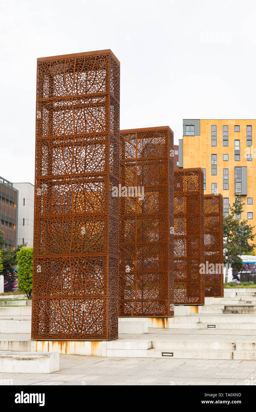 Birmingham, West Midlands, UK: Four monolith-shaped metal sculptures with filigree leaf designs located in the city centre Eastside City Park. Stock Photo