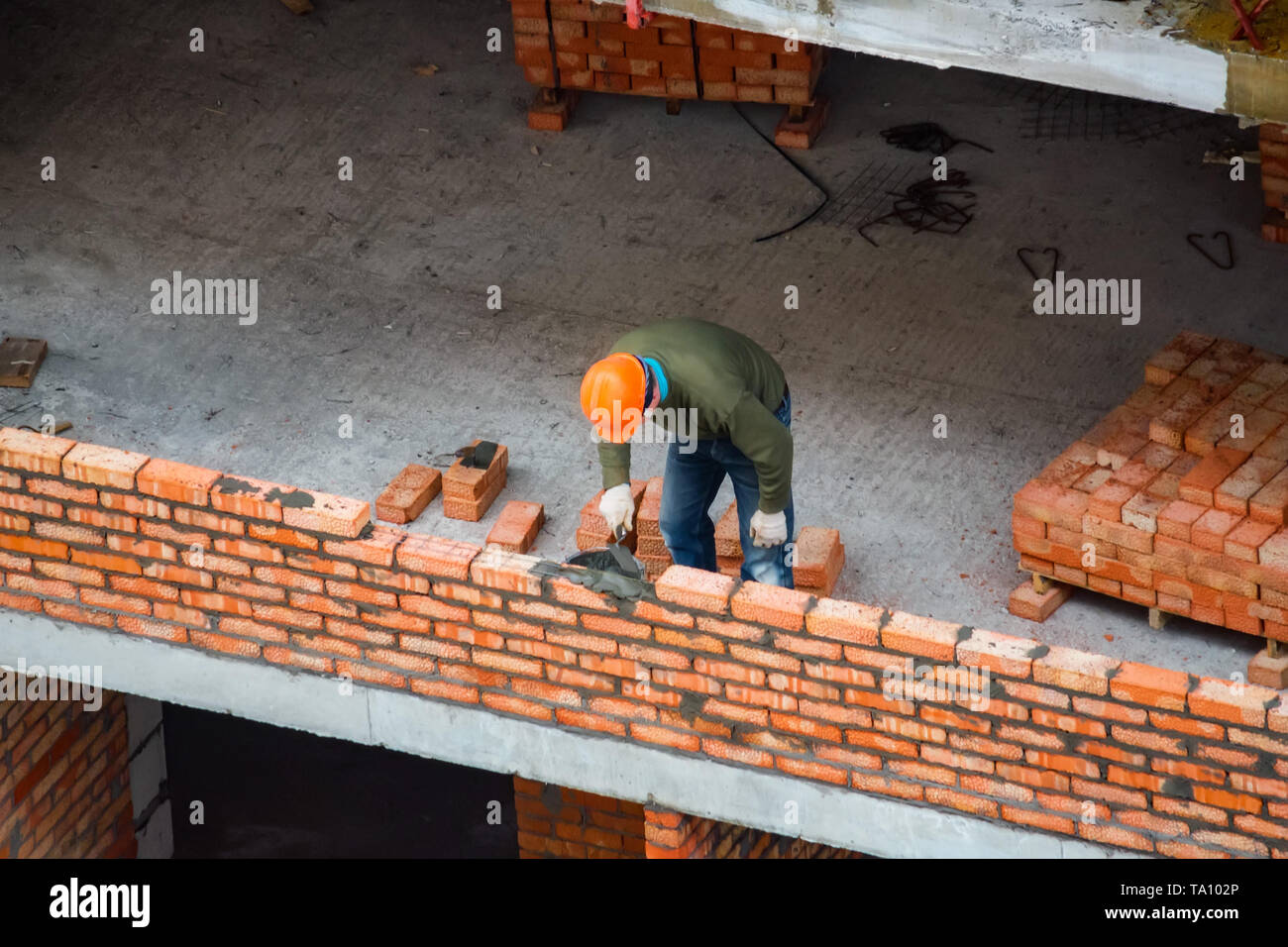 Worker Making Brick Wall At A New Building Construction Site Stock Photo Alamy