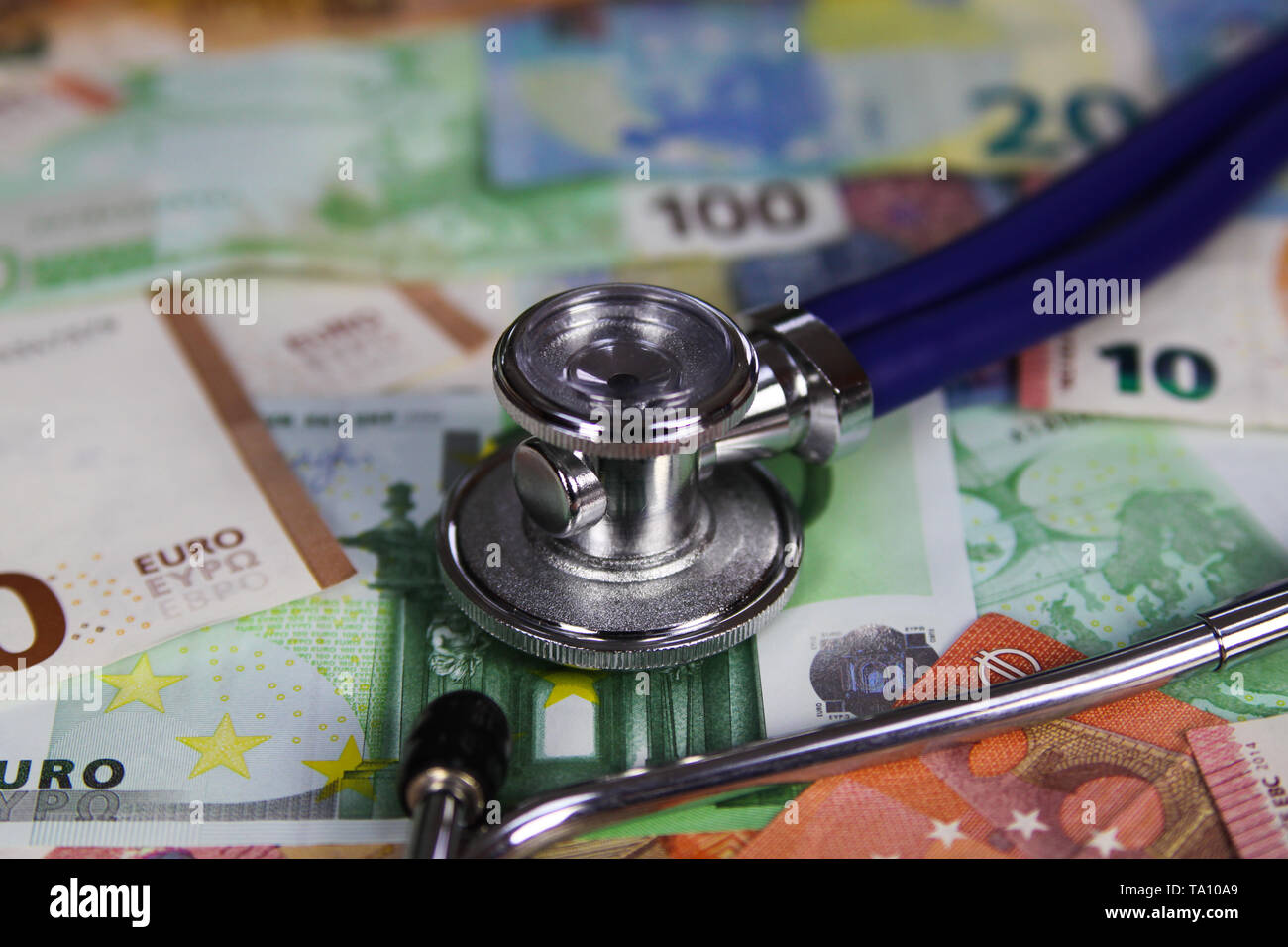 Medical cost concept - Stethoscope on euro paper money bank notes Stock Photo
