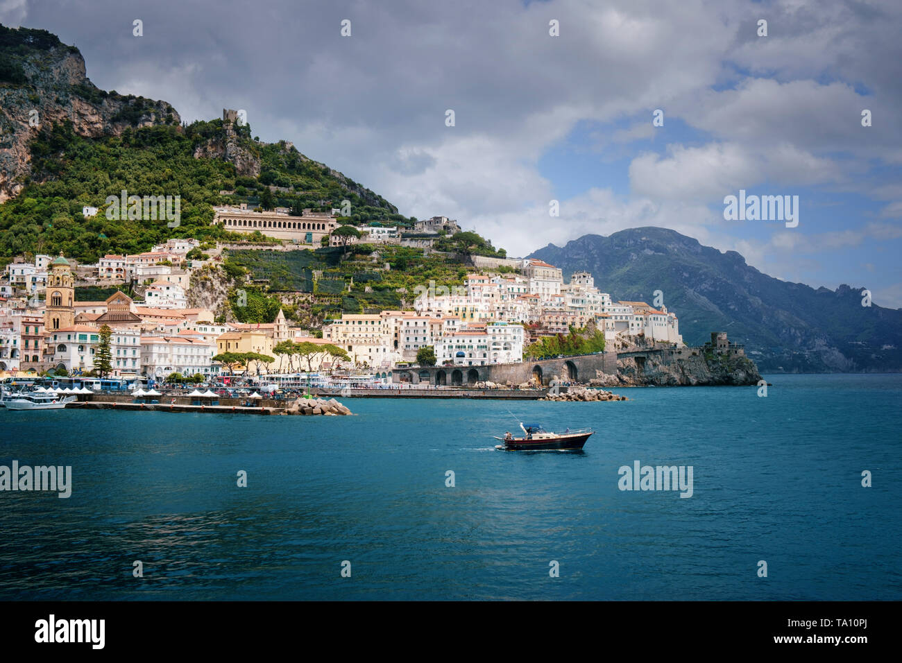 The boat heading out to the Bay of Salerno and Tyrrhenian Sea  from the coastal town of Amalfi on the Amalfi Coast of Campania in Southern Italy. Stock Photo