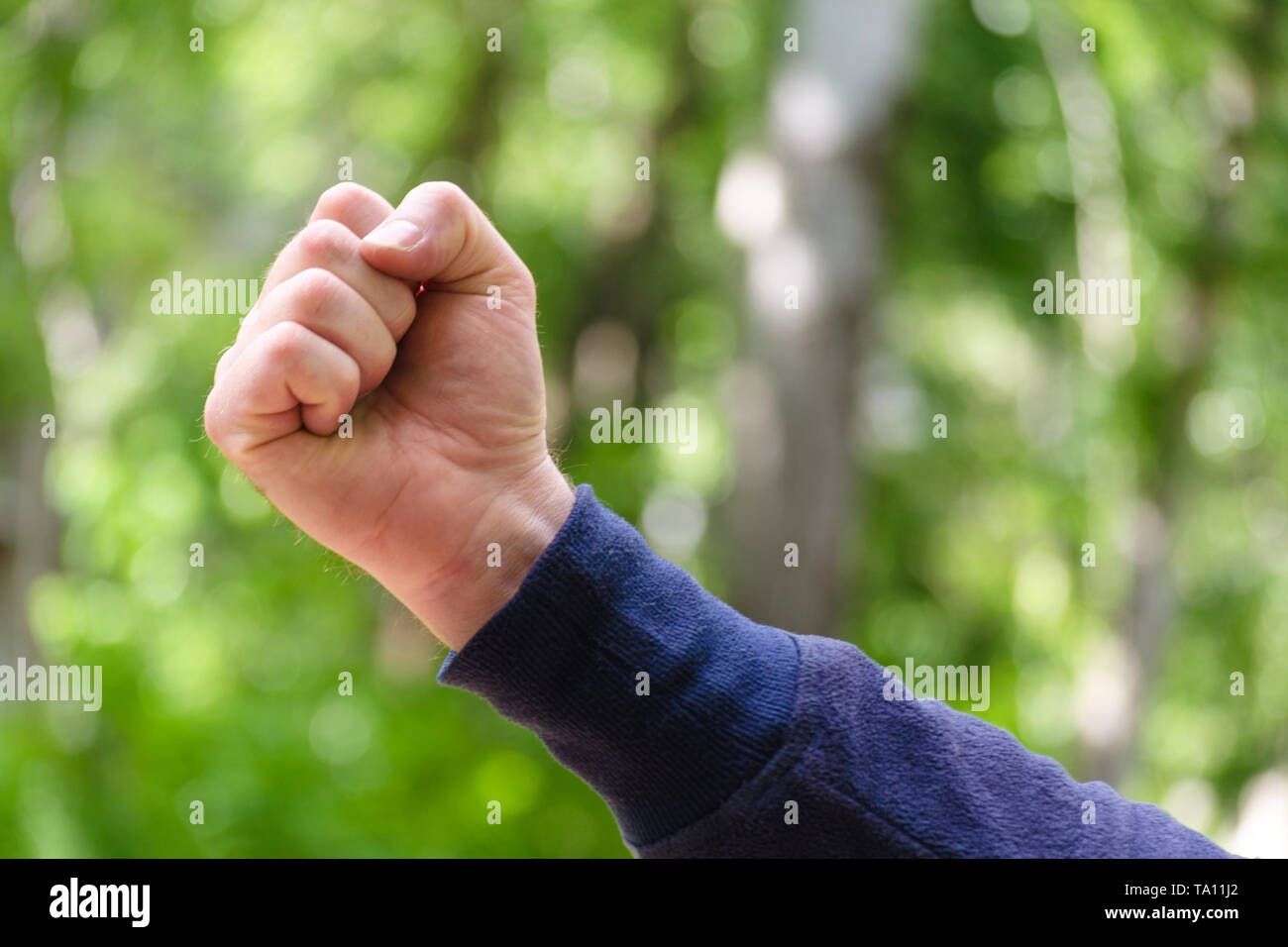 Clenched fist hand sign. Mens hand gesture of power and masculinity