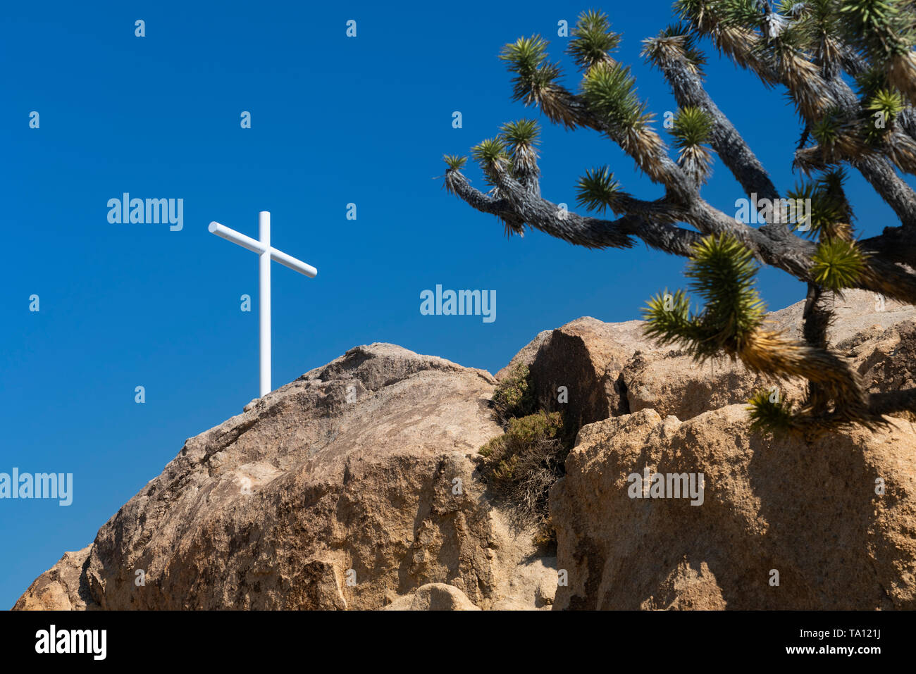 A white cross on a rock pile in the Mojave Desert, California, USA ...