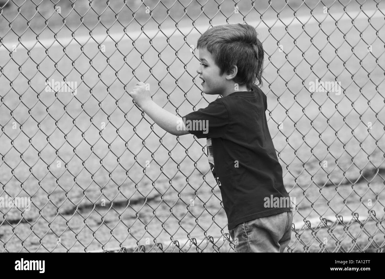 Montreal, Canada,May 20, 2019.Young boy looking through fence in Montreal,Quebec,Canada.Credit:Mario Beauregard/Alamy Live News Stock Photo