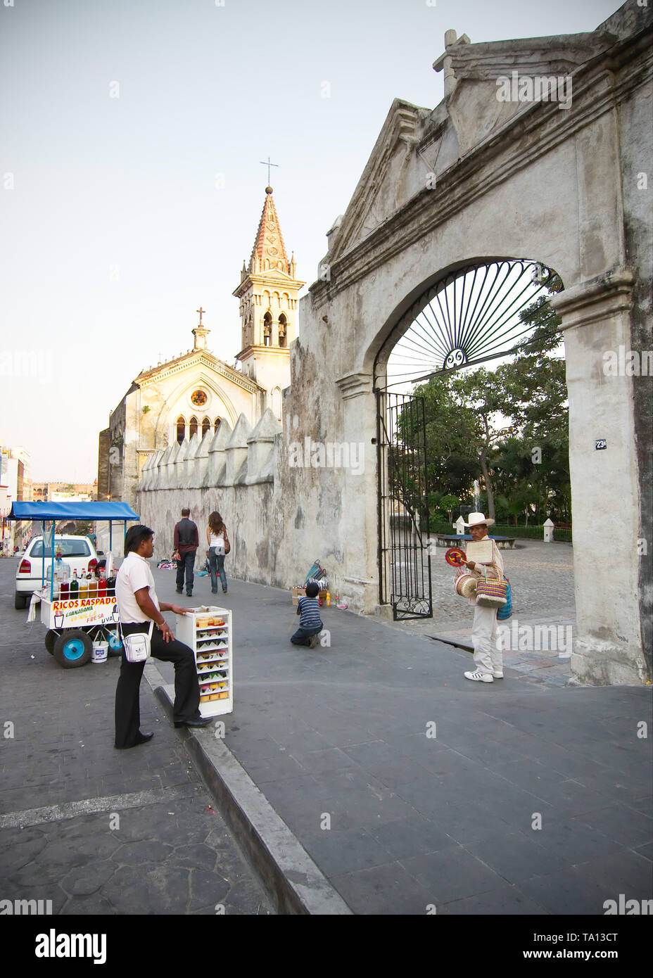 Cuernavaca, Morelos, Mexico - 2019: People sell local products in front of a chapel and the Cathedral La Asuncion. Stock Photo