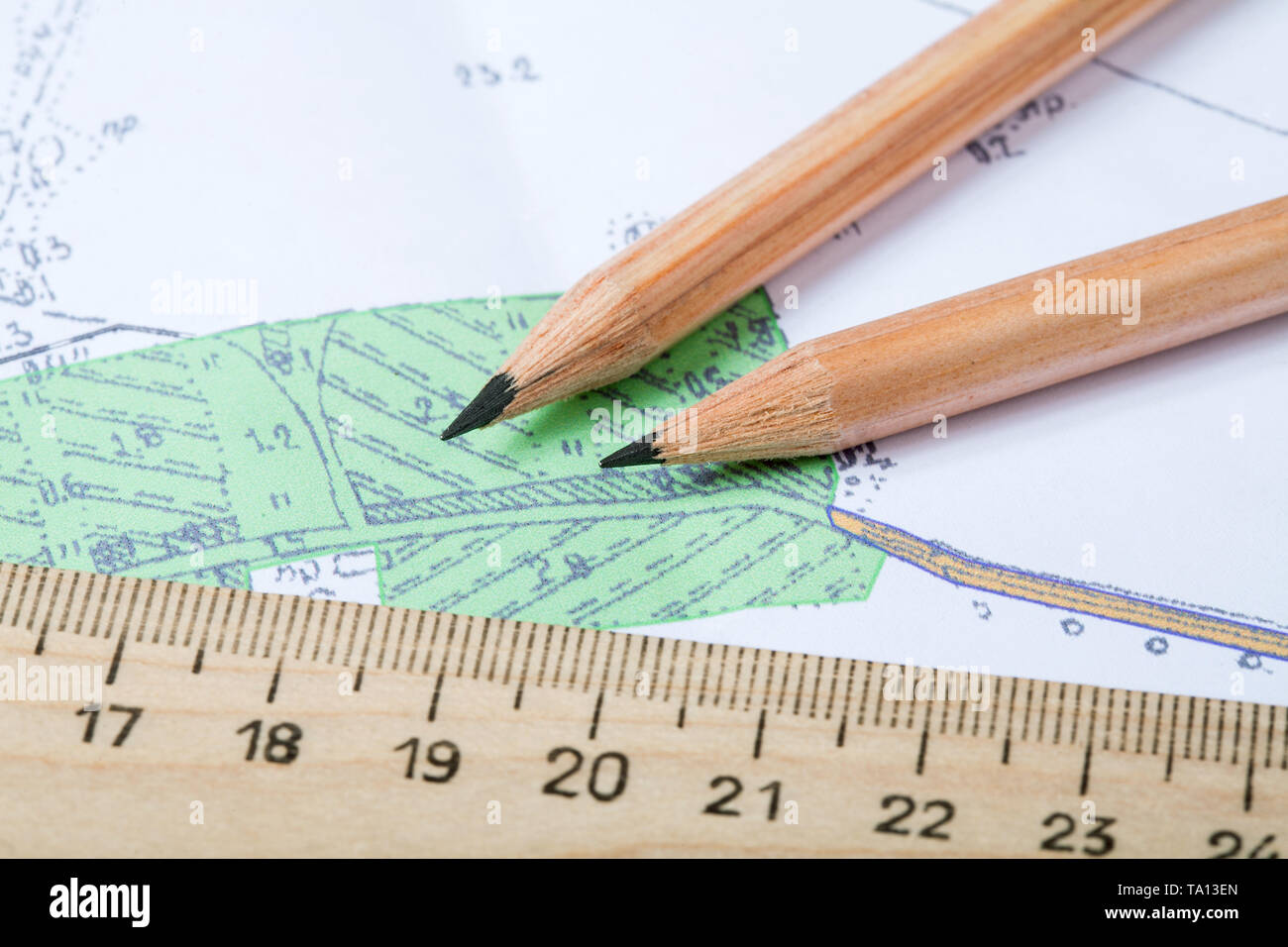 topographic map with pencils lying on it close up Stock Photo