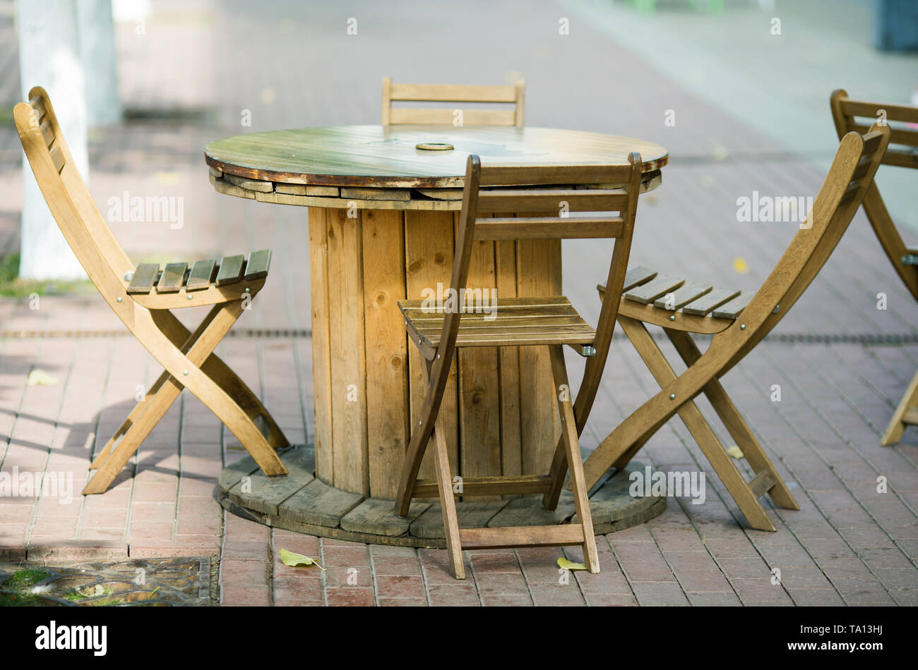 wooden chairs close-up in a street cafe fall Stock Photo