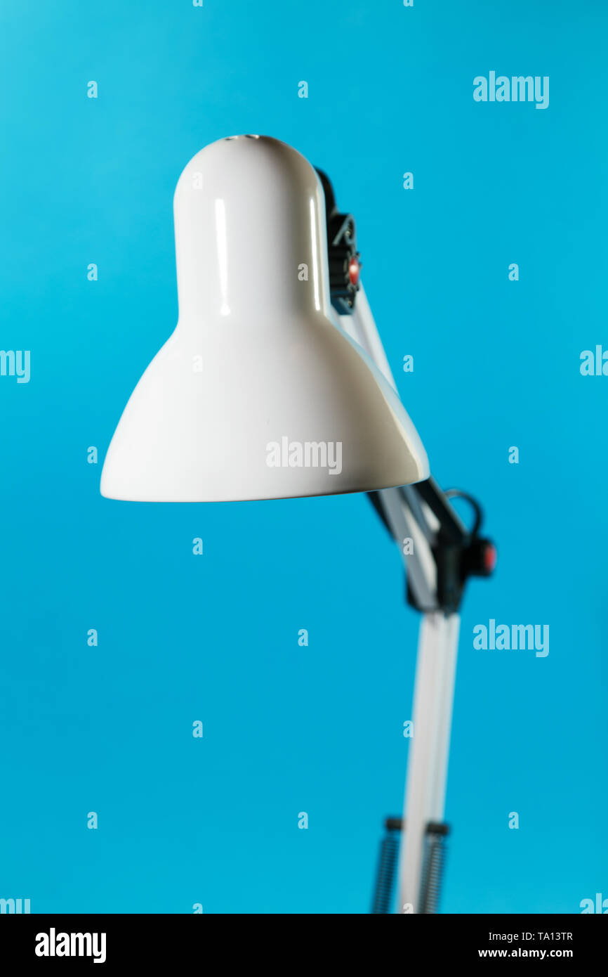 white table lamp close up on a blue background Stock Photo