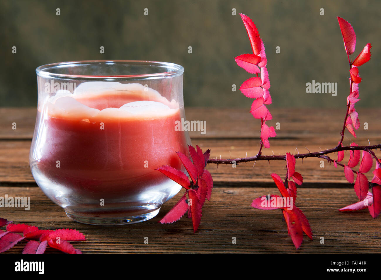 Still-life with a candle and dry red leaves Stock Photo