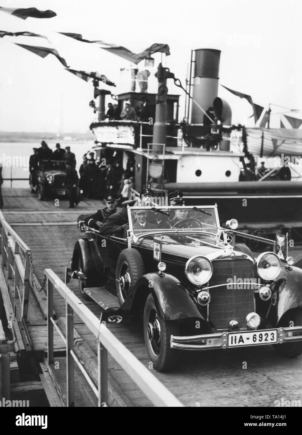 Propaganda Minister Joseph Goebbels is on the way to Neuteich, a municipality in Gdansk, in view of the parliamentary election in Gdansk. This photograph shows Goebbels in the passenger seat, along with other members of the NSDAP on the way to Neuteich. The flags on the car indicate that it is an official car of the NSDAP. Stock Photo