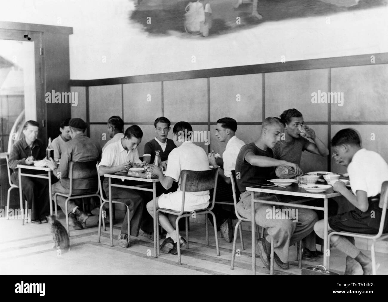 The Comite de la Jeunesse de France has set up an accommodation in Paris, which serves as a shelter for released young French prisoners of war. Young men eating. Stock Photo