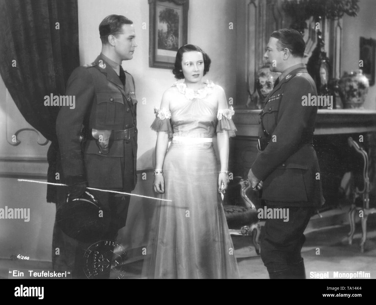 Gustav Froehlich as Lieutenant Bobby Tompson, Lida Baarova as the young widow Lady Milton and Georg Alexander as Colonel Hallifax in 'A Devil of a Fellow' directed by Georg Jacoby, based on a script by Paul Sugar. Stock Photo