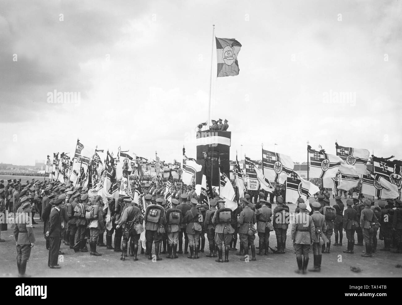 As part of the 13th Reichsfrontsoldatstag (Frontline Soldiers' Day), the 2nd leader of the Stahlhlem, Theodor Duesterberg, dedicates the Reichskriegsflaggen (imperial war flags) of 40 newly founded local groups. On a flagpole is a flag with the logo of the Stahlhelm. Stock Photo