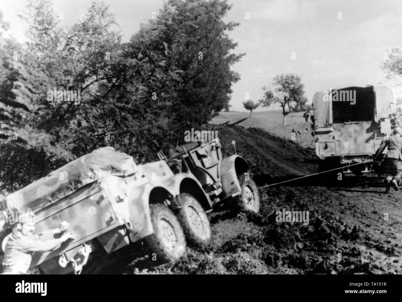 A German truck tries to pull a crashed Protzkraftwagen (Kfz. 69) out of a ditch. Stock Photo