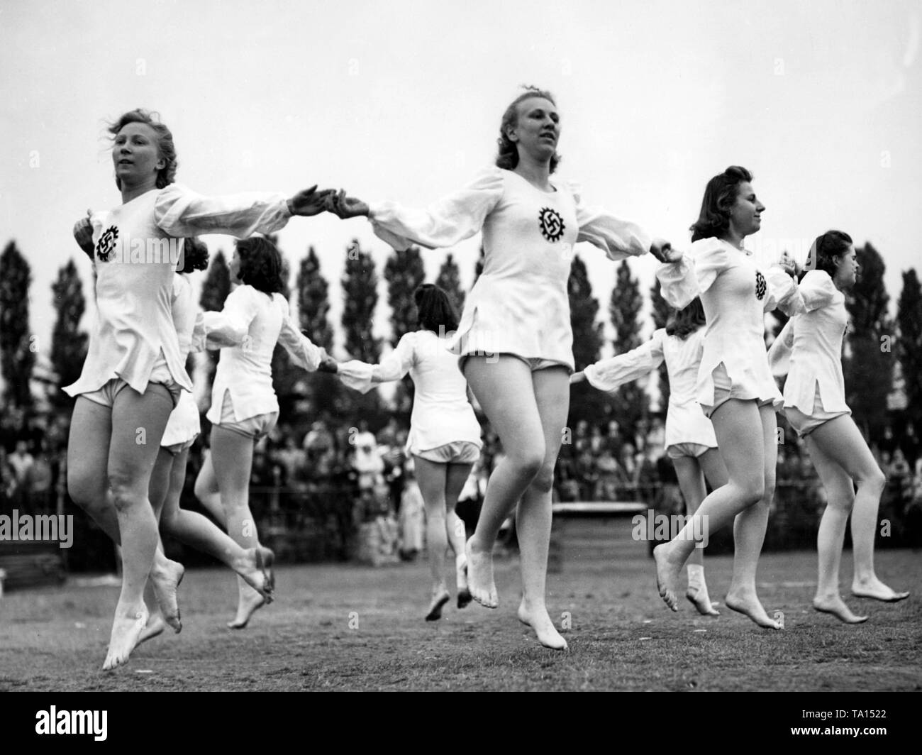Women do different exercises in a sports competition of the Nazi organization 'Kraft durch Freude' ('Strength through Joy') at the Funkturm Berlin. Here, women round dancing. Stock Photo