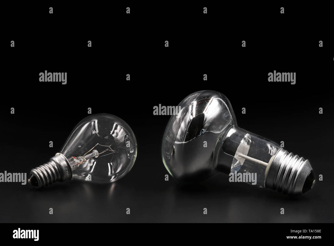 Two types of light bulbs on black background with copy space Stock Photo