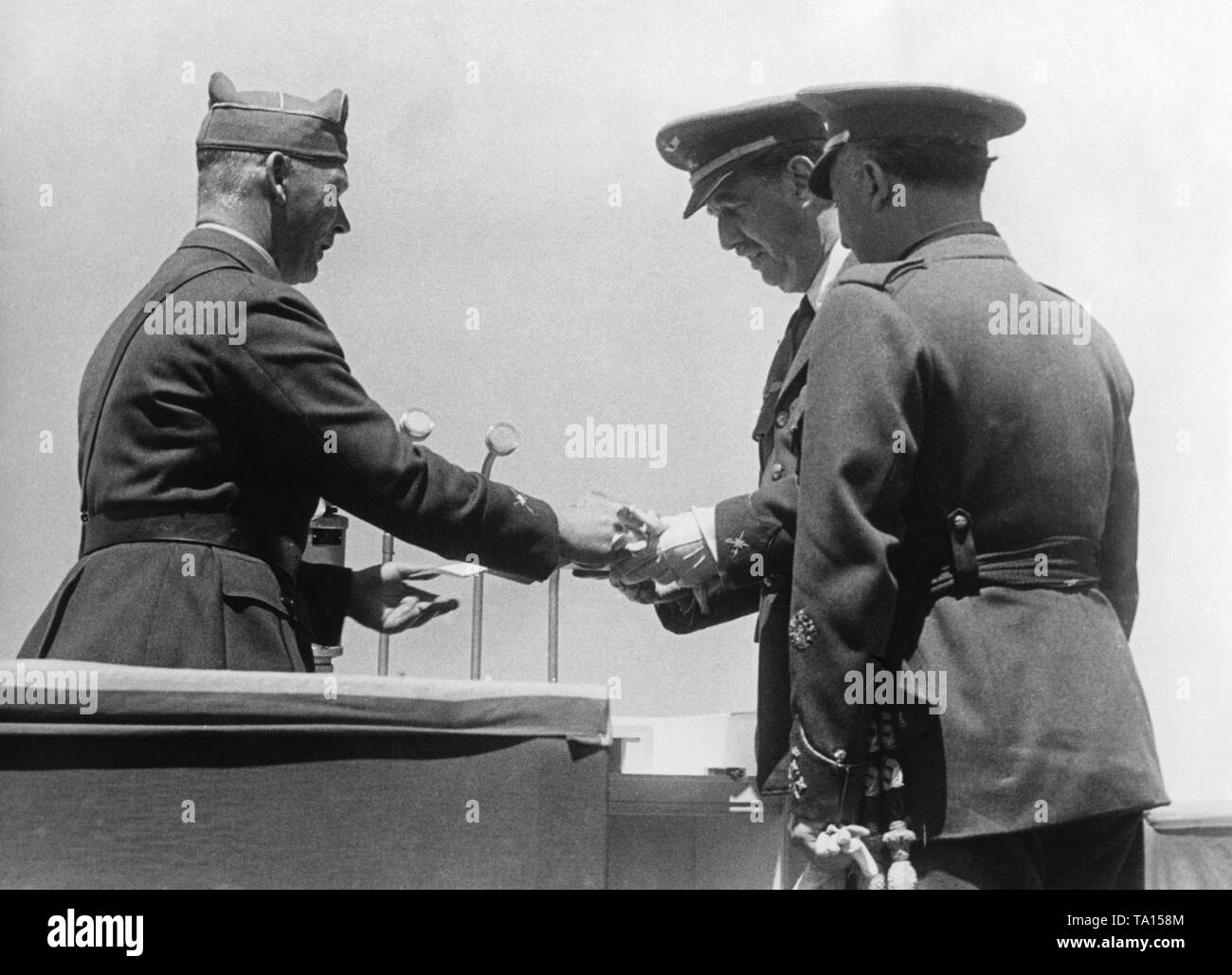 Photo of the commander of the German Condor Legion, major general Wolfram Freiherr von Richthofen (left), of the brigadier general of the Spanish Air Force, Alfredo Kindelan Duany, and of General Francisco Franco (right, in the back) on the lectern of the VIP stand during a victory parade at Barajas airport, Madrid, after the invasion of the city on March 28, 1939 . Stock Photo
