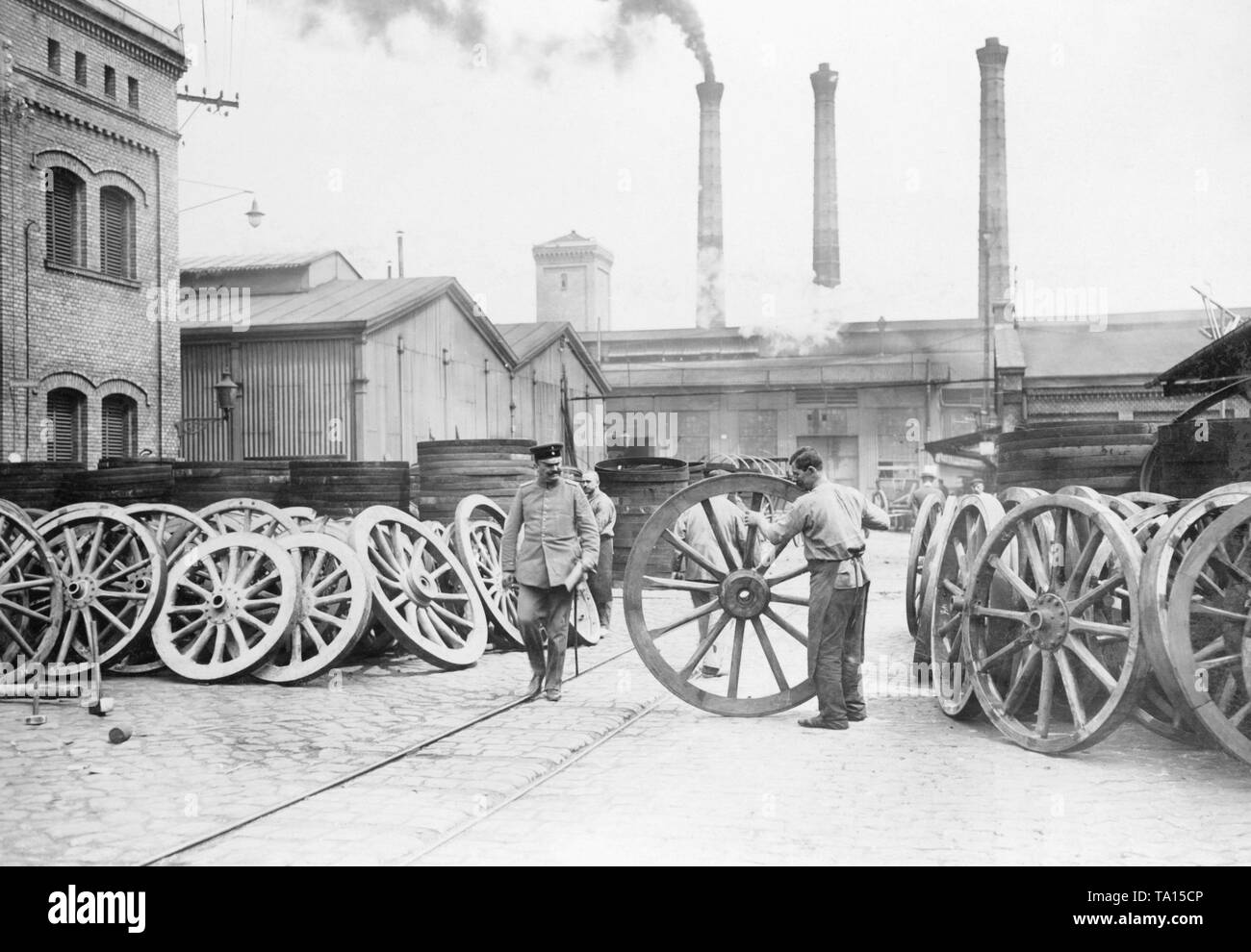 Worker working on wheels for artillery pieces. Here, in the yard of a wheelwright, in which the