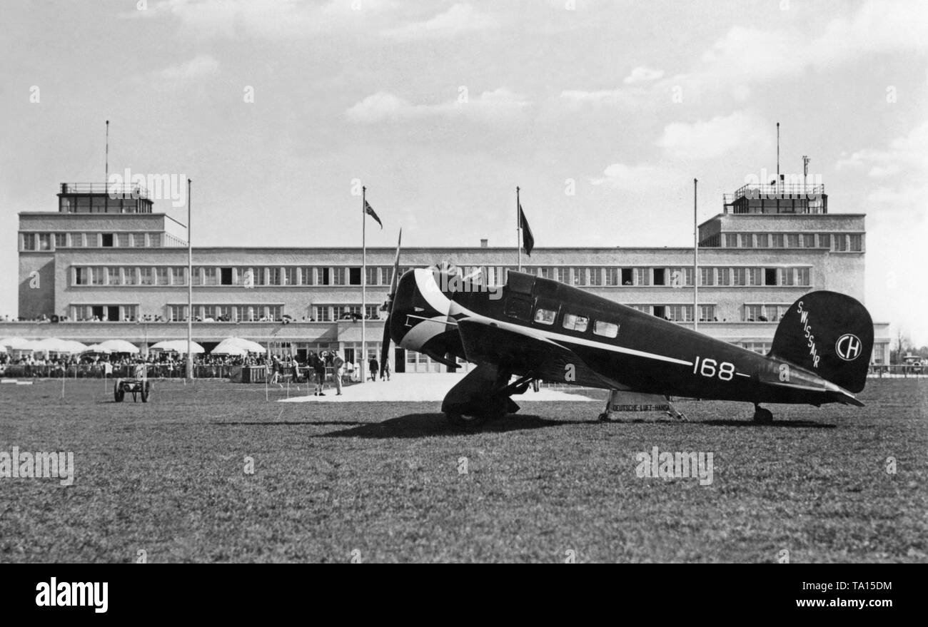 A Lockheed 9B Orion of Swissair on the apron of the Munich airport Oberwiesenfeld. The numerous spectators in the background and that this aircraft was at that time the fastest in the world, suggests a possible air show on this day. Stock Photo