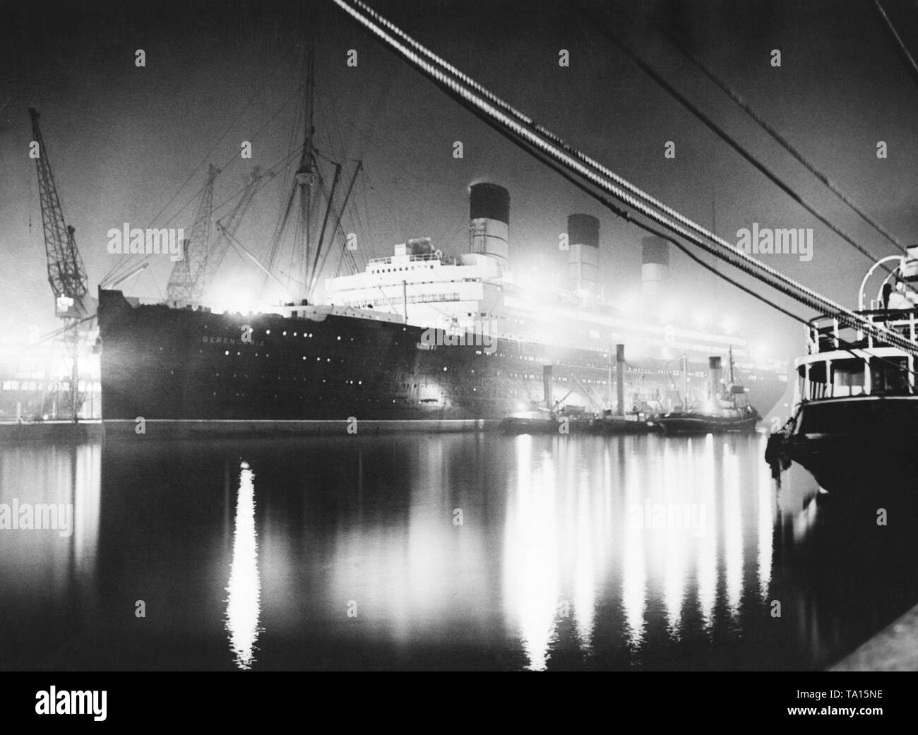 The ocean liner "Berengaria" of the Cunard Line is berthed at the equipment quay of a shipyard