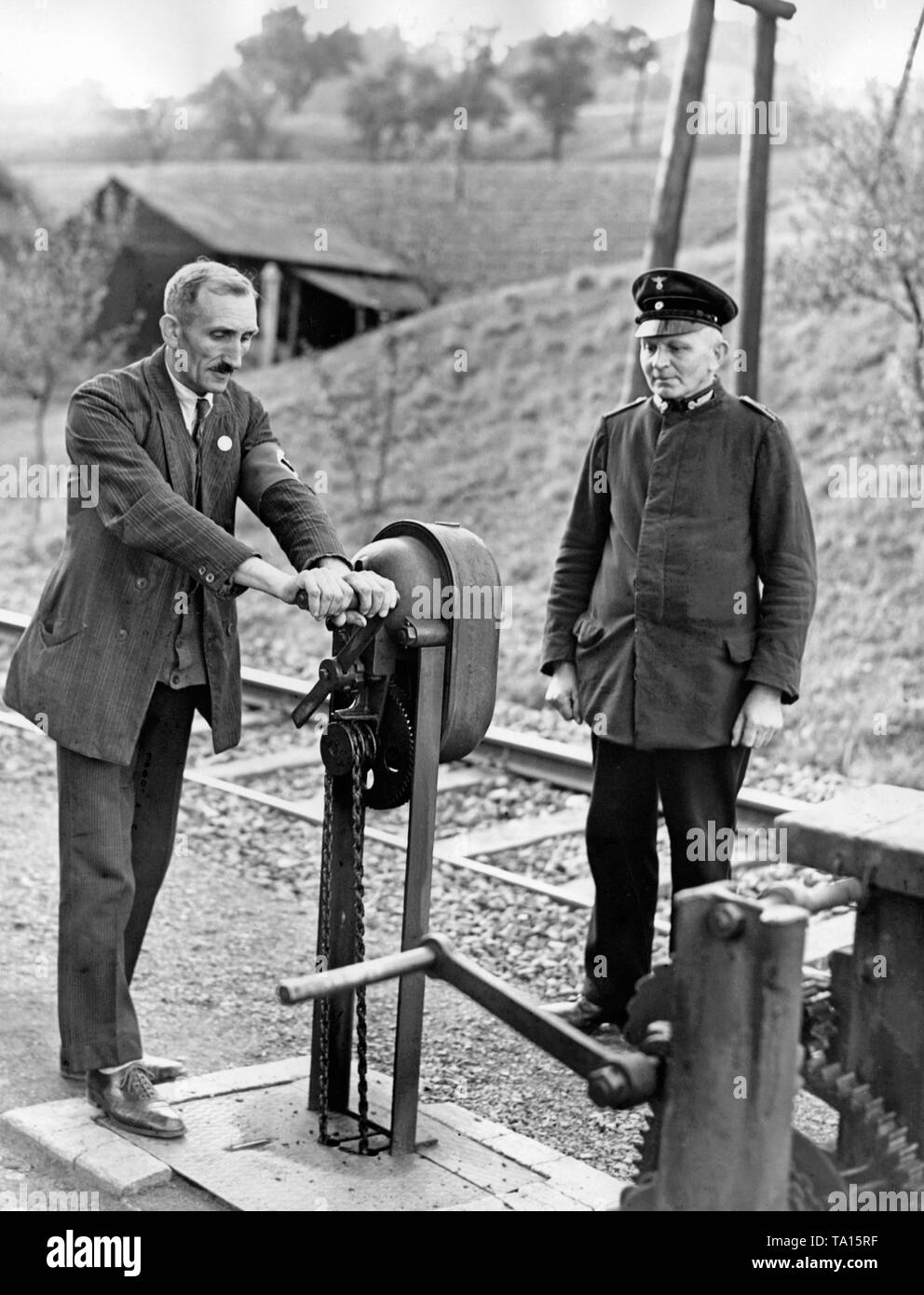 A railway official instructs a candidate from the Sudetenland in the operation of the signal and barrier systems on October 16, 1938, in  Alt Schokau (today Stary Sachov). Stock Photo