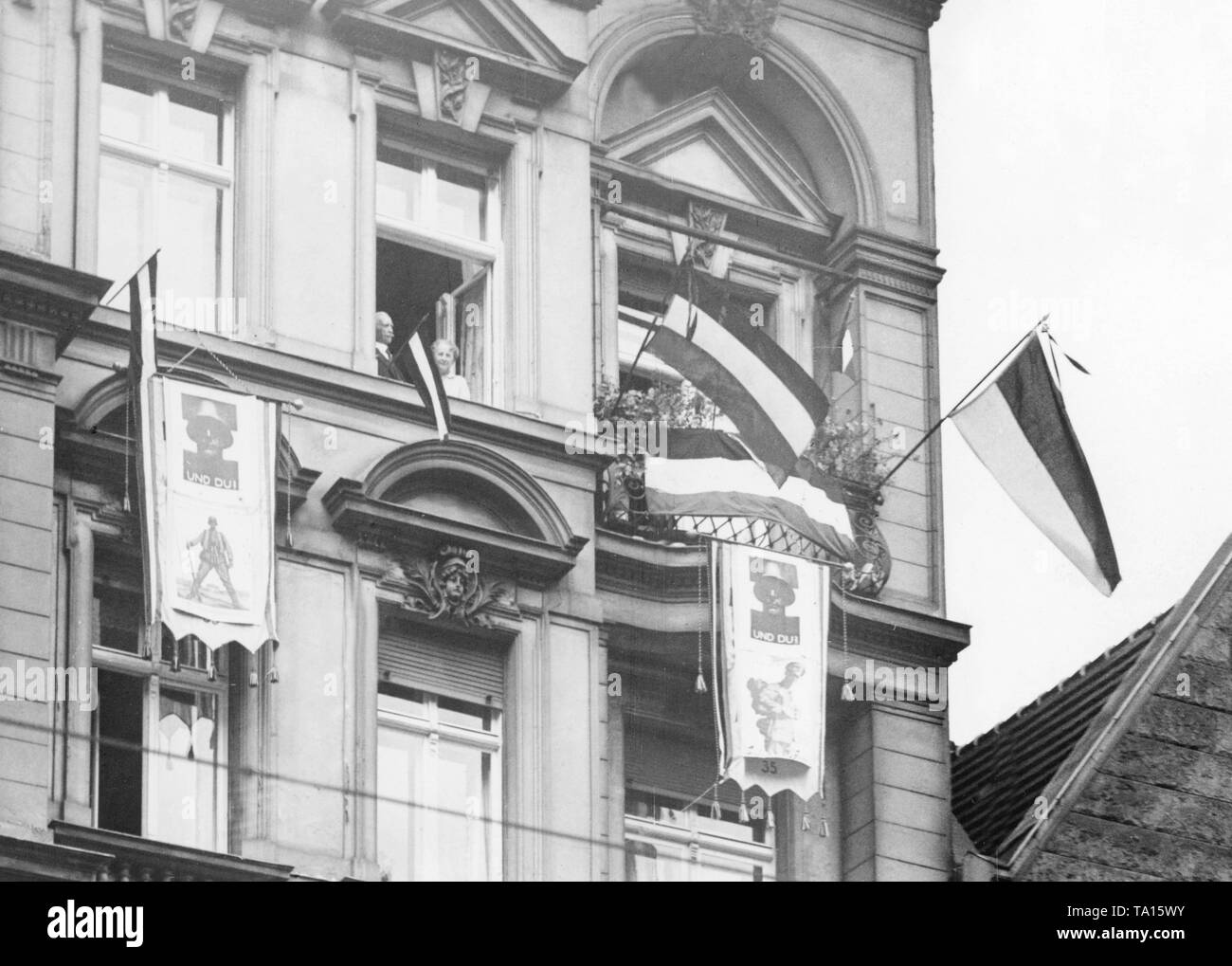 These Berliners are evidently enthusiastic about the Stahlhelm, as they hang flags of the empire out of the window and posters of the Stahlhelm on their facade. Stock Photo