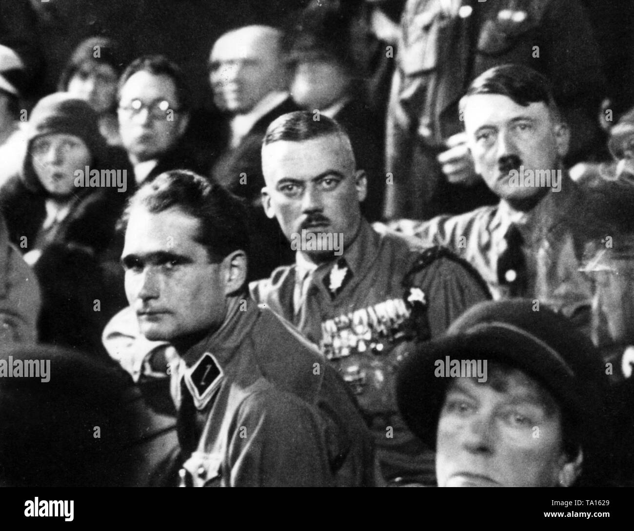 From left: the deputy of Hitler, Rudolf Hess, the head of the SA Franz von Pfeffer and Adolf Hitler during a speech of Privy Councilor Alfred Hugenberg in the Munich Circus Krone. Occasion of this speech was the referendum against the adoption of the Young Plan to regulate the reparations debt. The 'Reichsausschuss fuer den Volksbegehren' (Reich Committe for Referendum), in which all the anti-Republican parties, including the NSDAP, are represented, becomes a springboard to Adolf Hitler into the great politics. Stock Photo