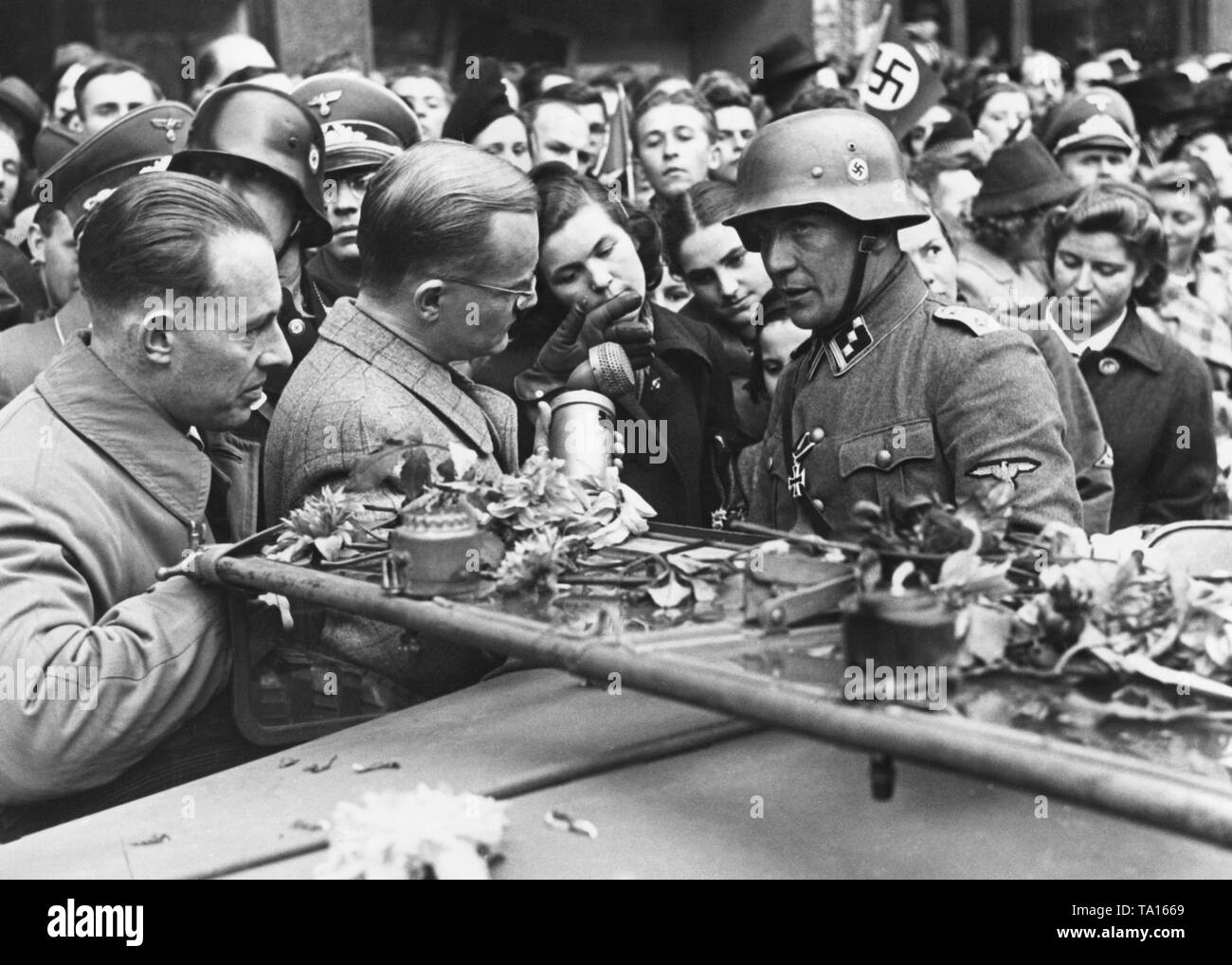 After having been deployed on the Eastern Front, the SS Leibstandarte (Guard of Corps) returns to Prague. The company commander gives a radio interview during the celebrations. In September, Hitler starts World War II by attacking Poland. Stock Photo