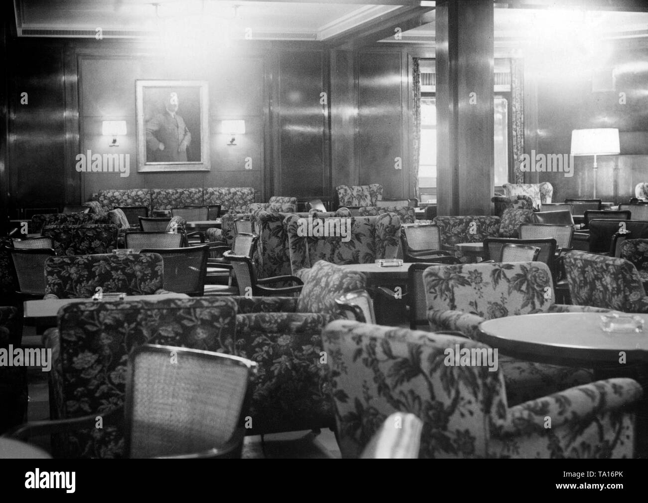 Photo of the smoking lounge of the cruise ship of the Nazi organization 'Kraft durch Freude' ('Strength through Joy'), 'Wilhelm Gustloff', during its first two-day trip to the North Sea with 1000 Austrian vacationers on board. On the wall there is a portrait of Adolf Hitler. Stock Photo