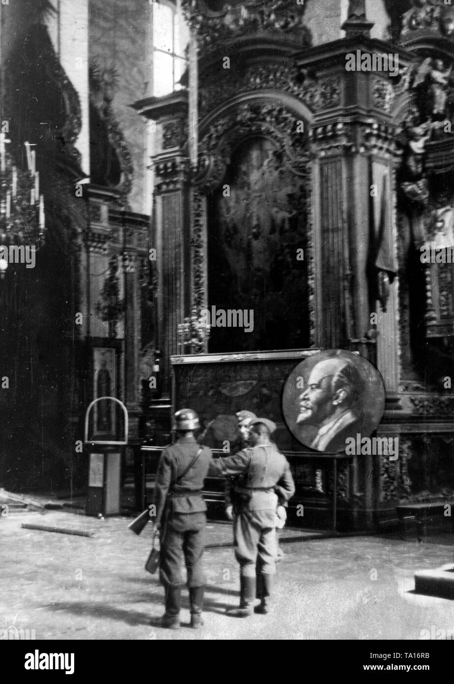 German infantrymen in the Cathedral of Smolensk. The portrait of Lenin is evidently a photomontage, which was to serve German propaganda. Allegedly, the Soviets converted the church into a Lenin Museum. Stock Photo
